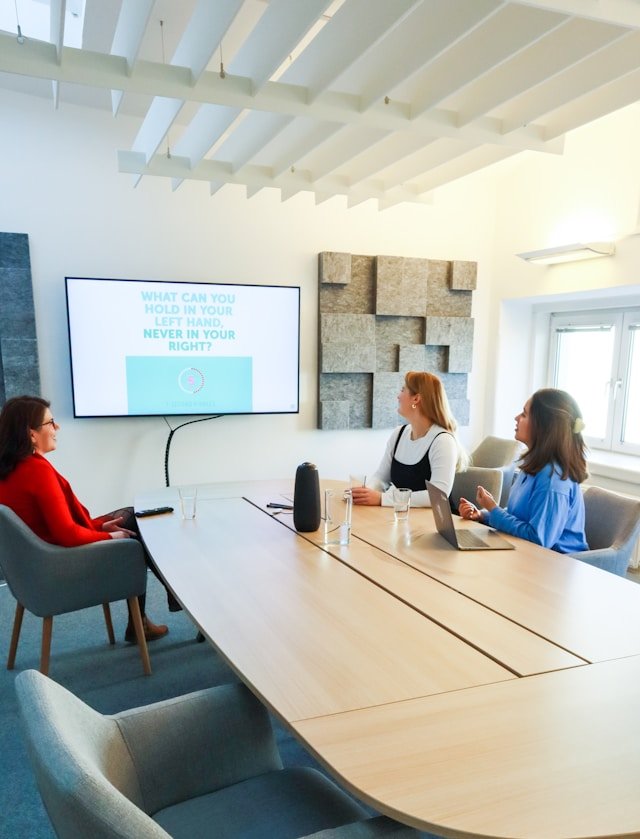 Business Strategy Meeting and Team Presentation Team of professionals attending a business presentation in a modern meeting room, discussing strategy and ideas