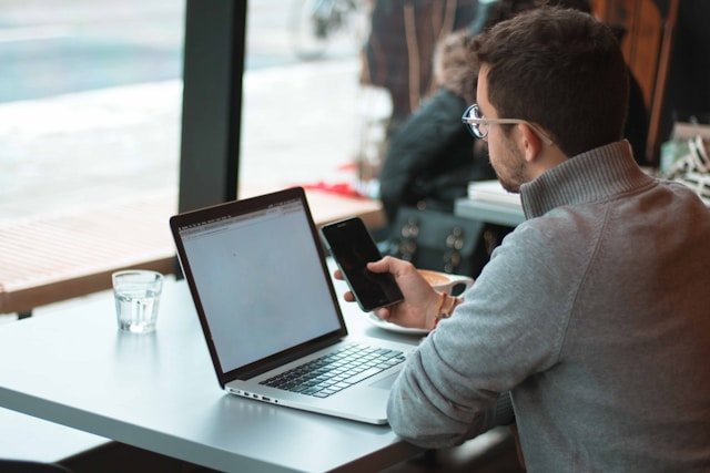 Professional-working-on-laptop-with-analytics